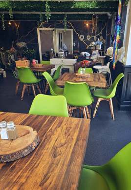 Tables and green chairs in the community café